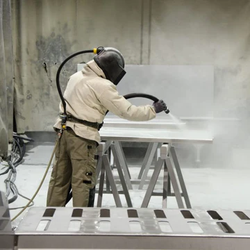 Sandblasting the surface of a Steel Craft baking steel